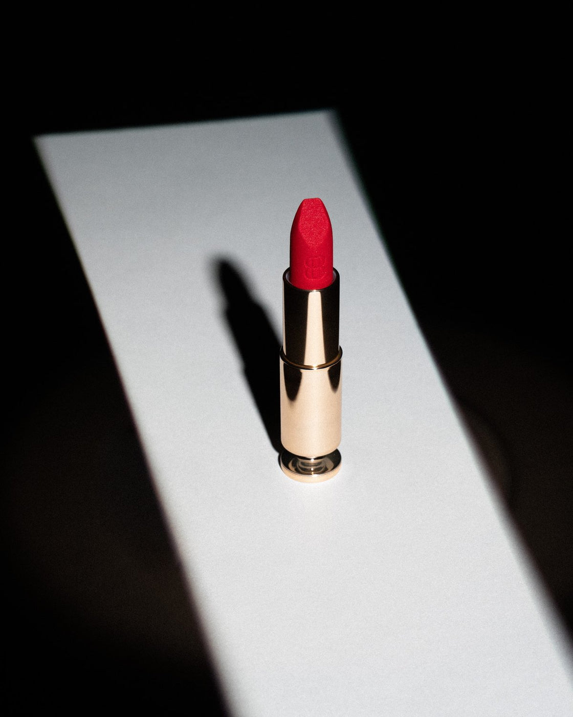 A BANG BANG lipstick in a beam of light