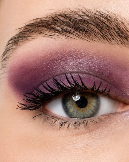 Close-up of an eye with plum shadow and lengthened lashes