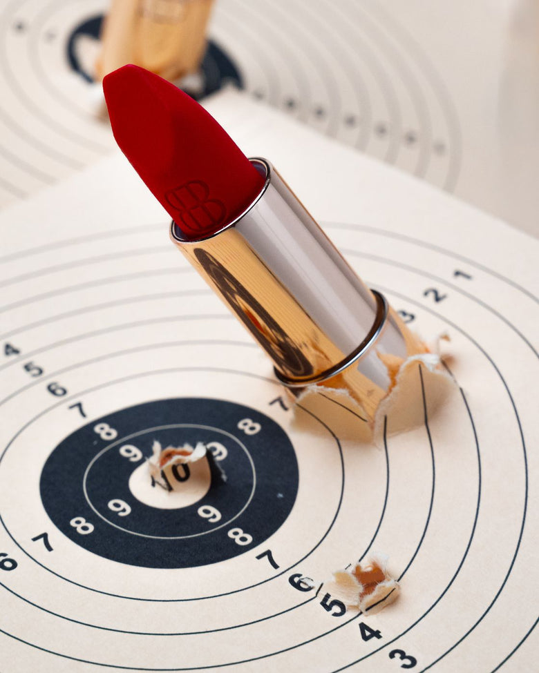 A lipstick planted in the bull’s-eye of a shooting target